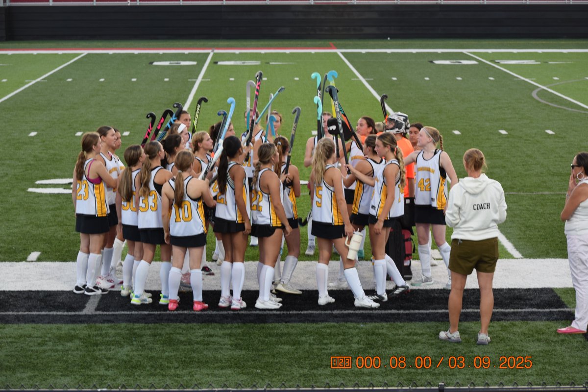 Team huddle, sticks up